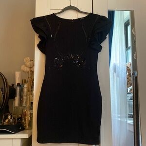 Black mini dress with ruffle sleeves. Size M. Front top has black sequins